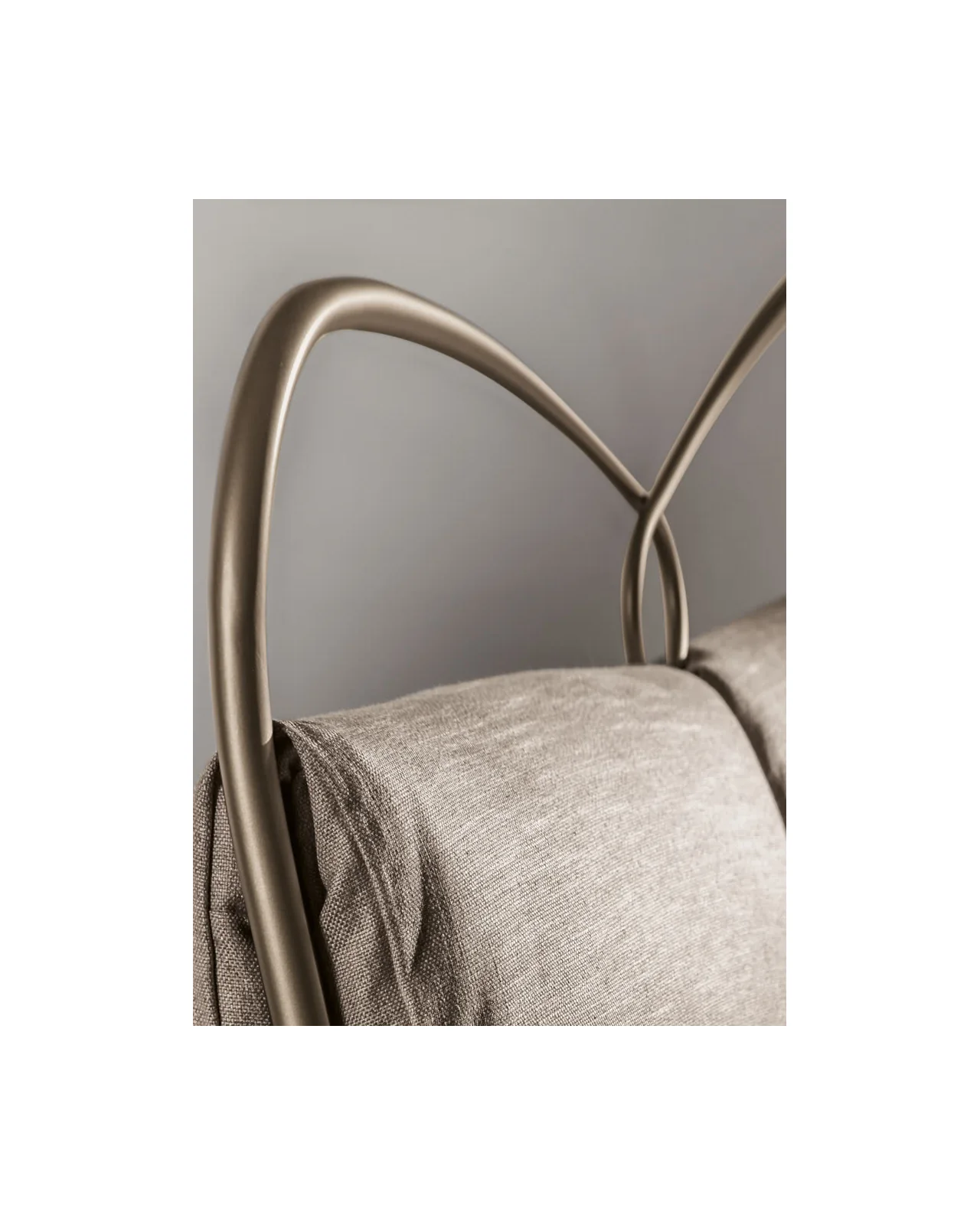 Metal ring headboard over a padded bed frame, Italian furniture in Milan