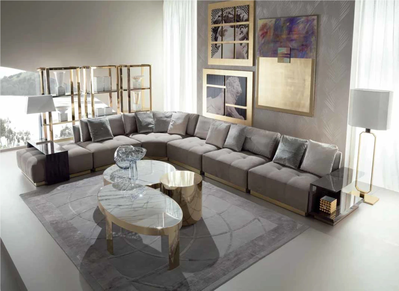 Grey modular sectional sofa around an oval glass coffee table, high end Italian furniture in London